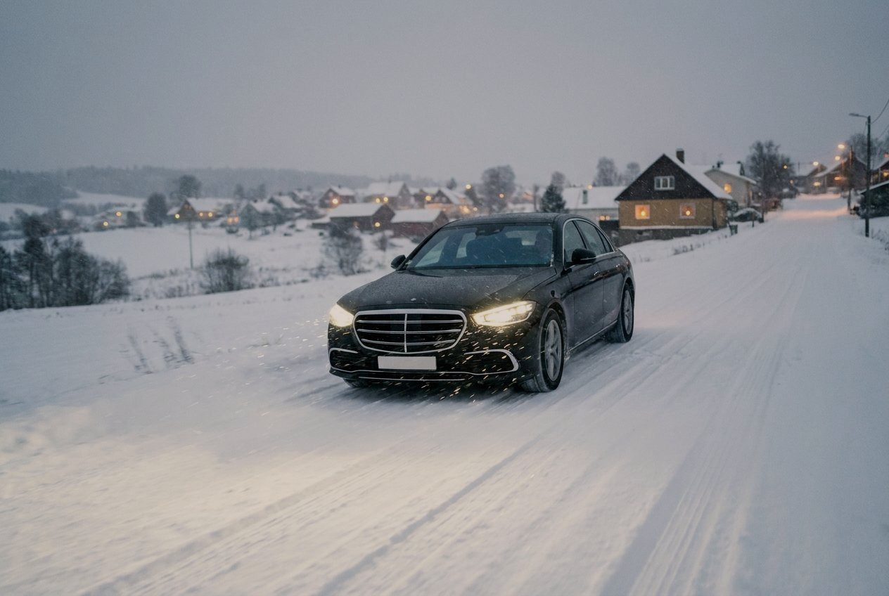 Chauffeured car in snowy alpine village at night